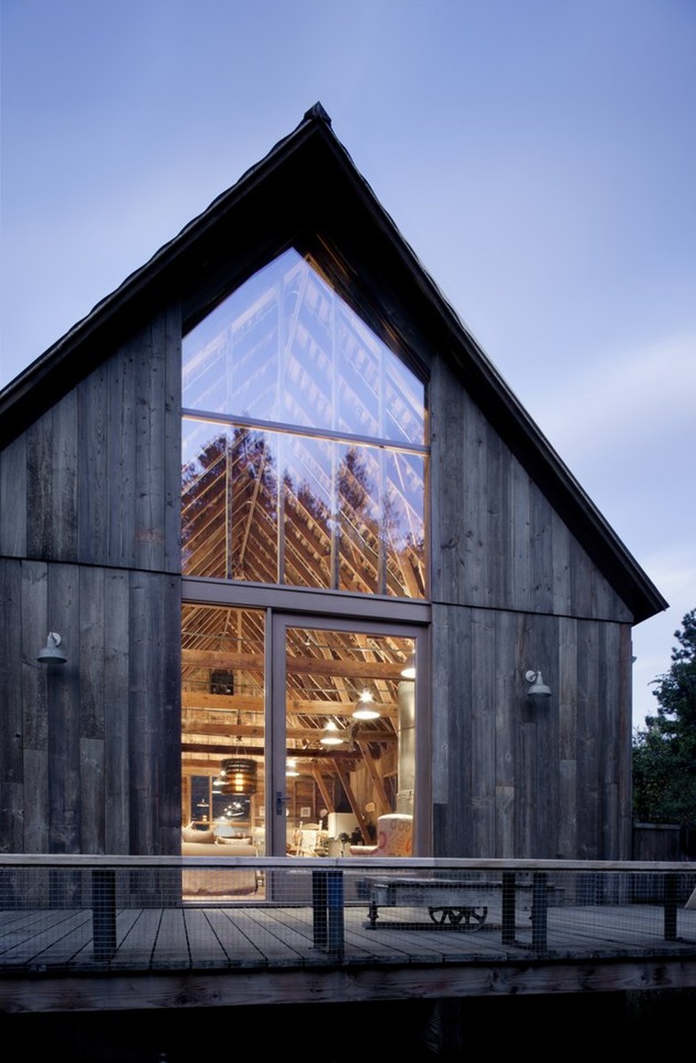 An a-frame barn with floor-to-ceiling windows