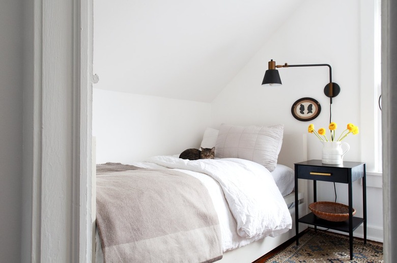 small bedroom with single bed and adjustable farmhouse lighting