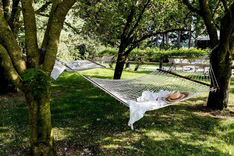 two crochet hammocks suspended on large trees