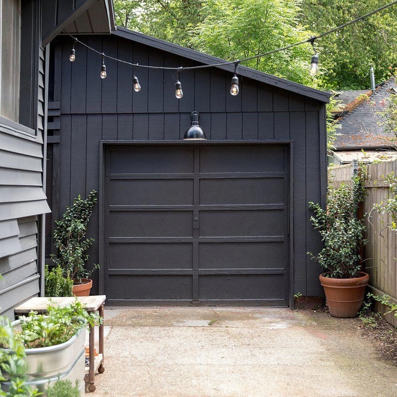 black paneled modern garage doors with modern lighting