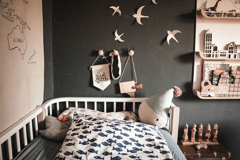 modern kids bedroom idea with black walls and light wood accents