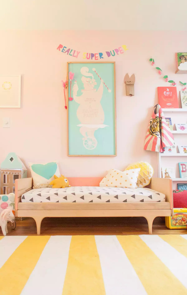 modern kids bedroom idea with pink walls and striped rug