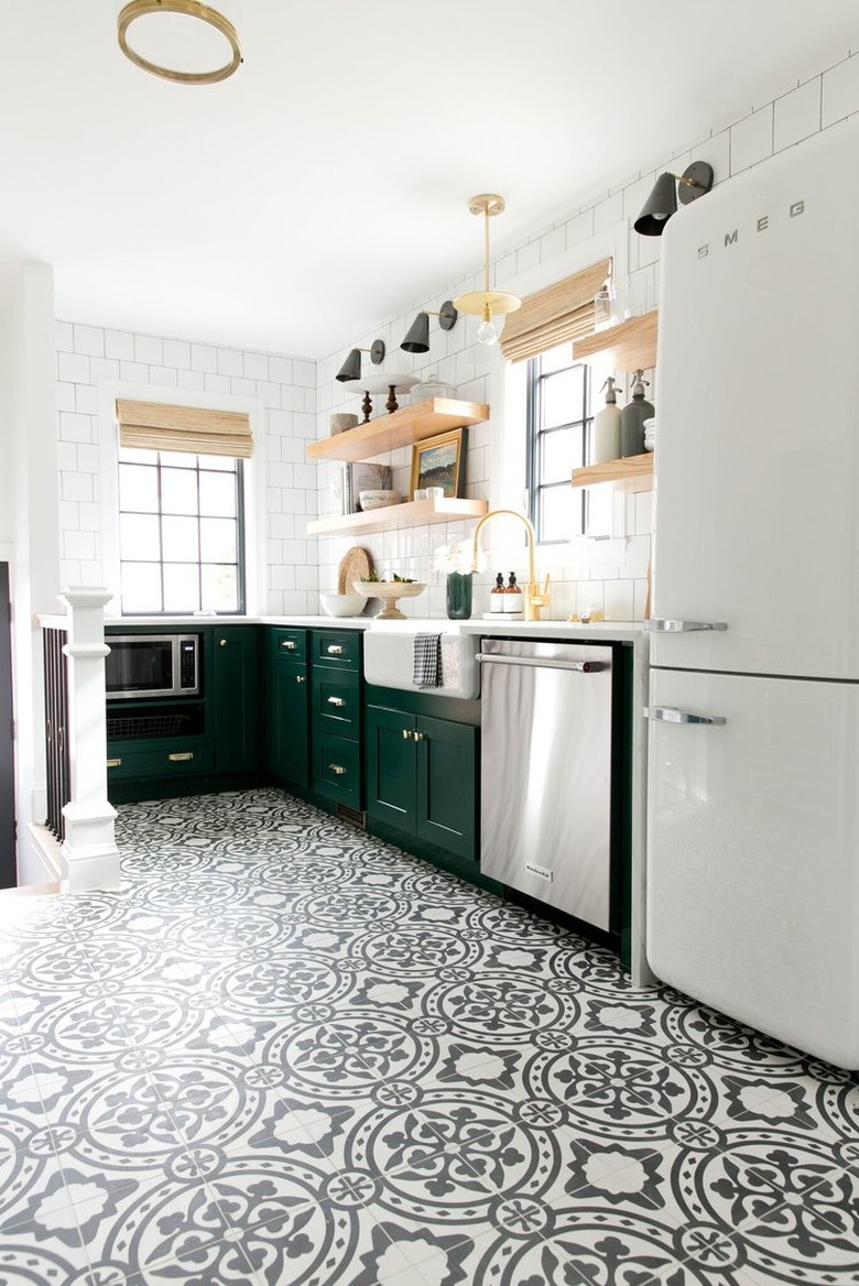 Black and white patterned tile modern kitchen flooring in modern kitchen with green cabinets