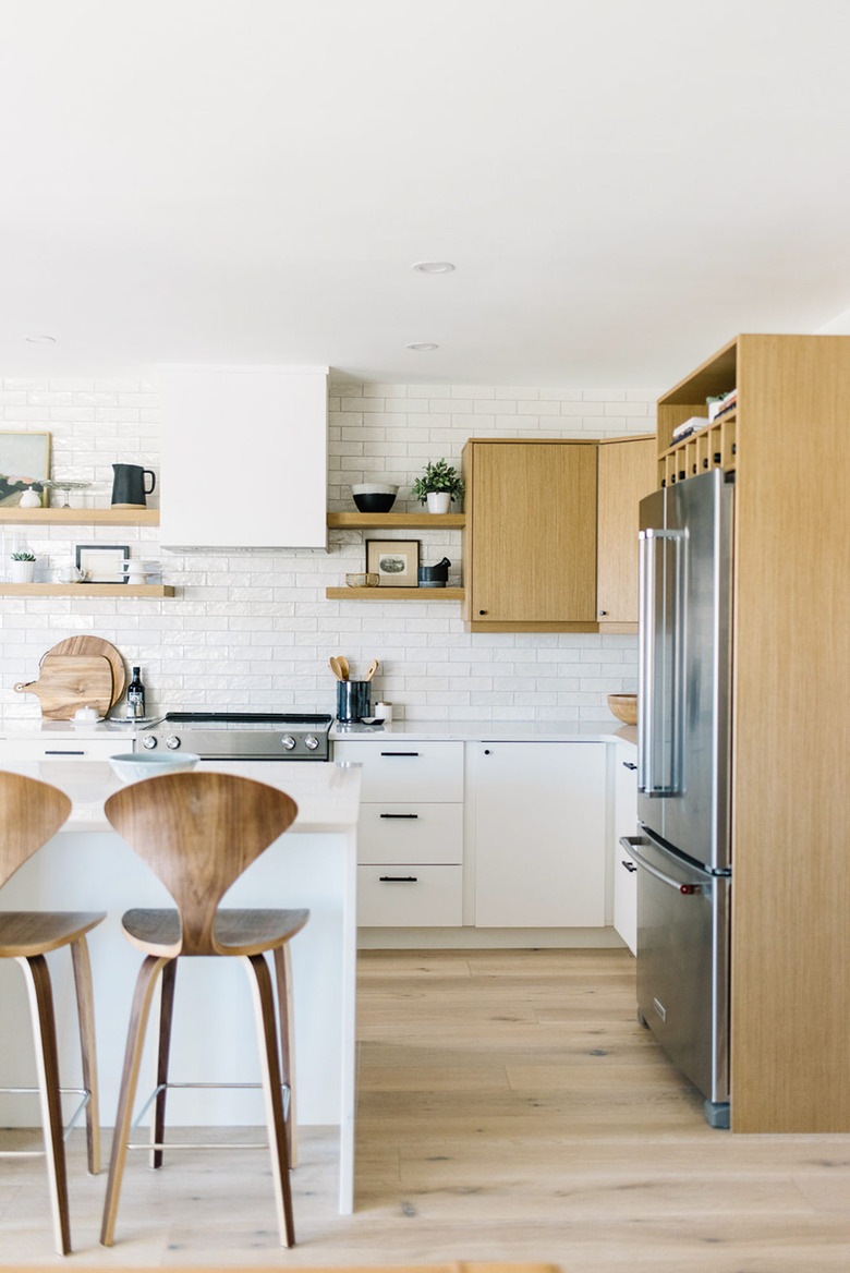 modern kitchen idea with white backsplash and wood cabinets with white countertop