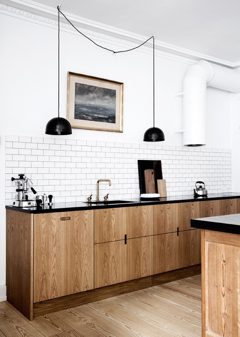 Scandinavian modern kitchen idea with black accents and sleek cabinets