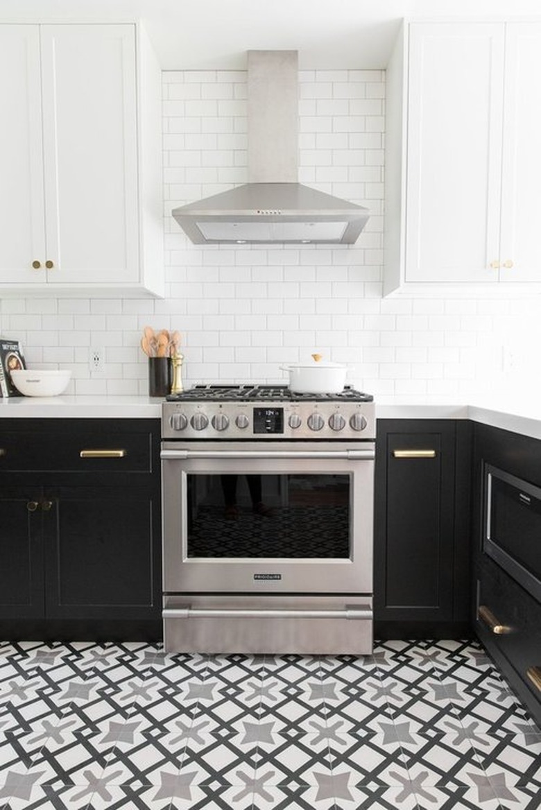 black and white Moroccan kitchen floor tiles with black cabinets and white countertops