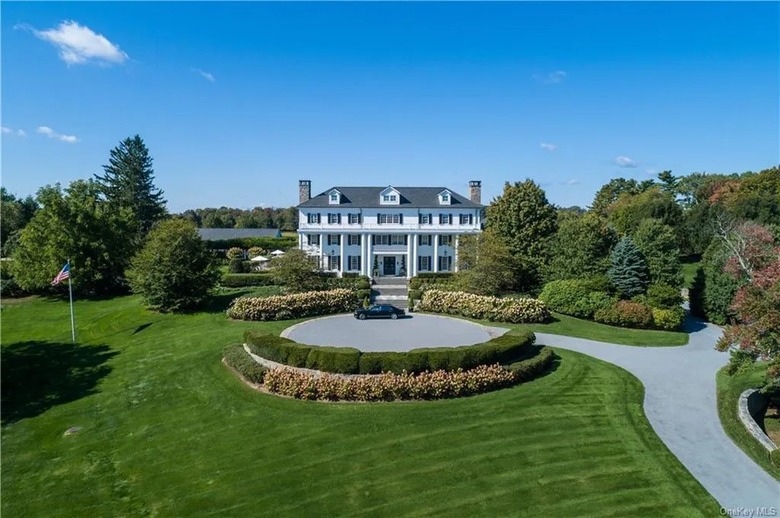 view of mansion with trees