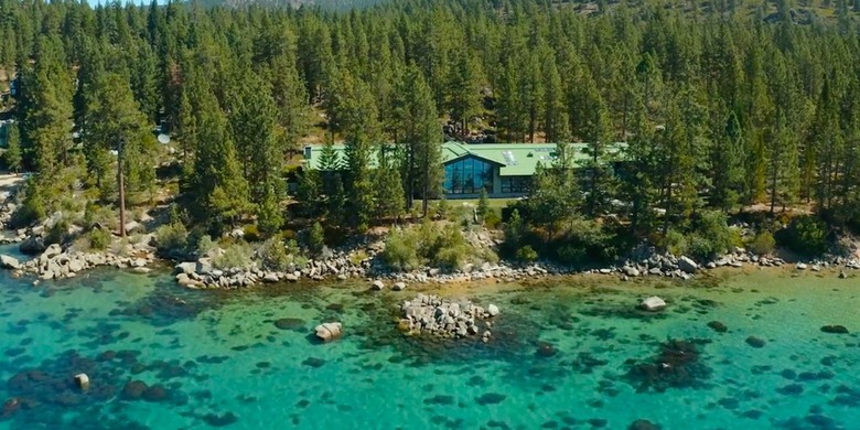 home amidst trees and near water seen from above