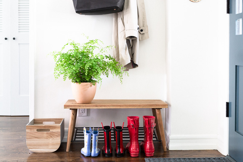 makeshift mudroom storage with bench and hooks