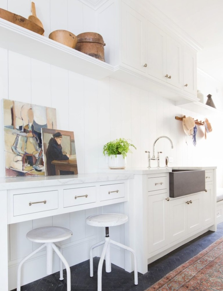 white mudroom storage with soapstone sink