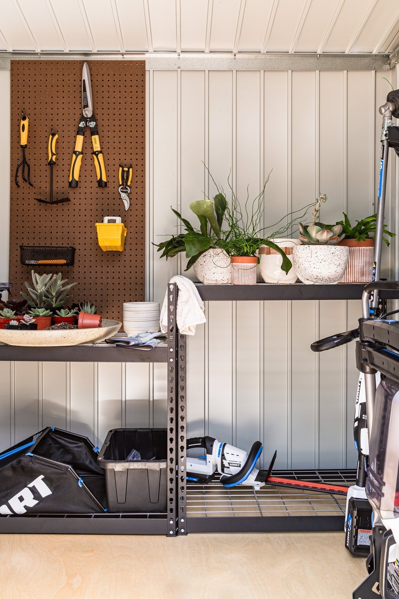 outdoor shed with tools and plants