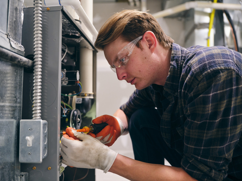 Home Repairman Working on a Furnace