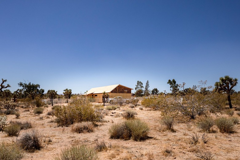 A house under construction in the desert with blue skies