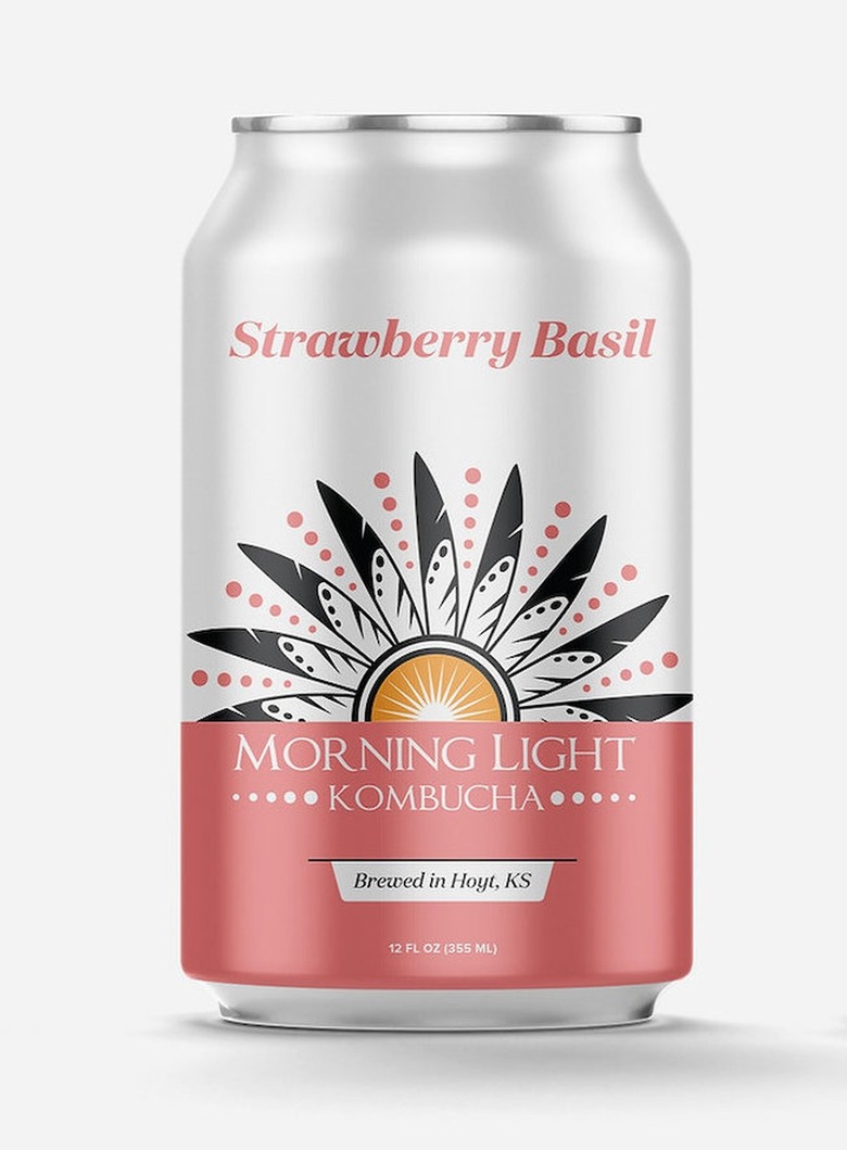 A can of strawberry basil kombucha over a white background.