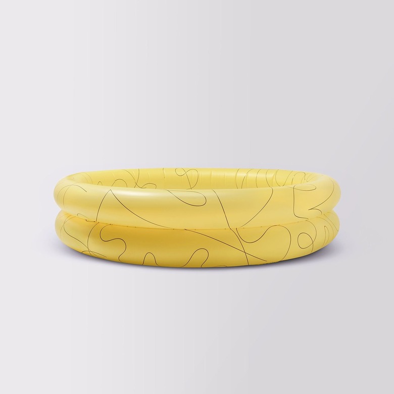 A yellow kiddie pool with decorative black swirls.