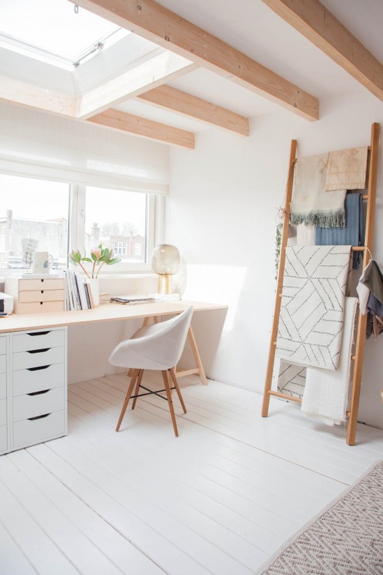 neutral home office with modern desk and blanket ladder