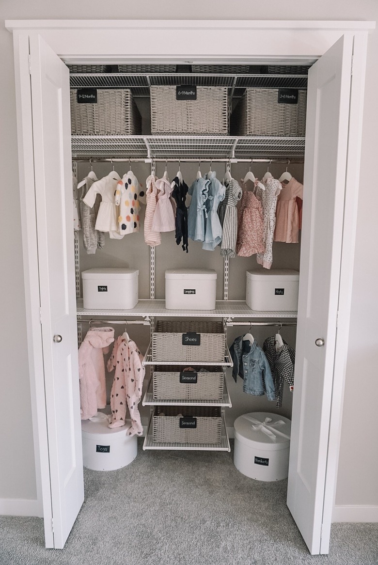 nursery organization in closet with bins and and shelving