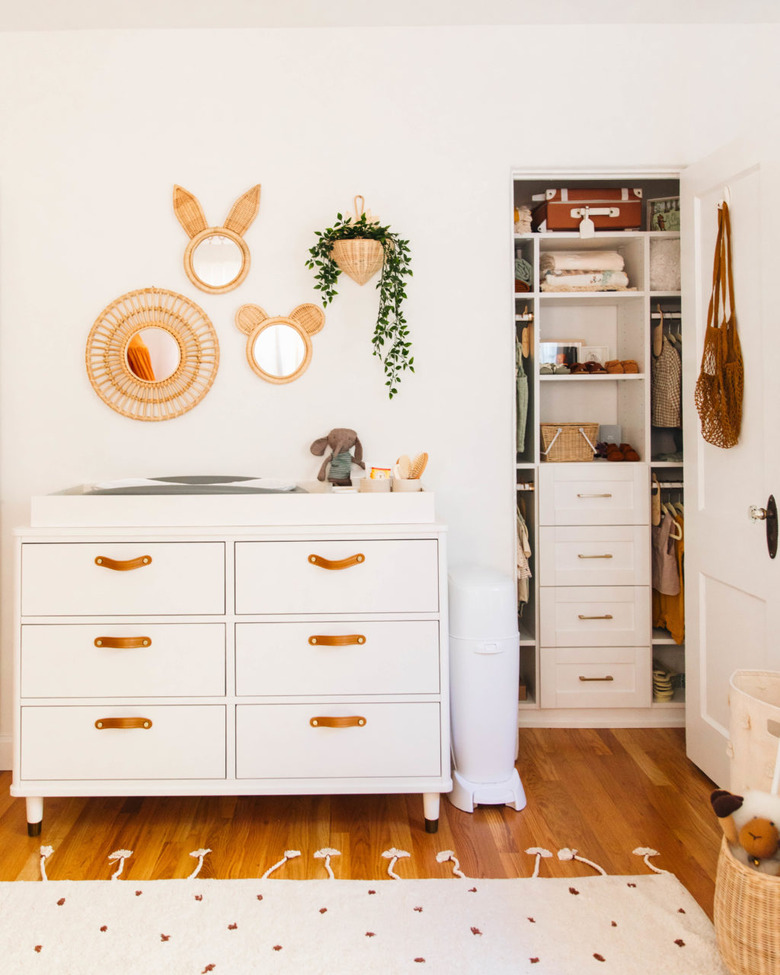 Small closet nursery organization with drawers and shelving