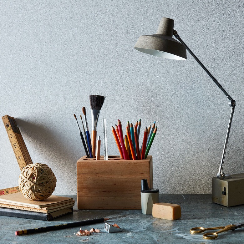 office organization supplies on gray desktop with lamp and caddy