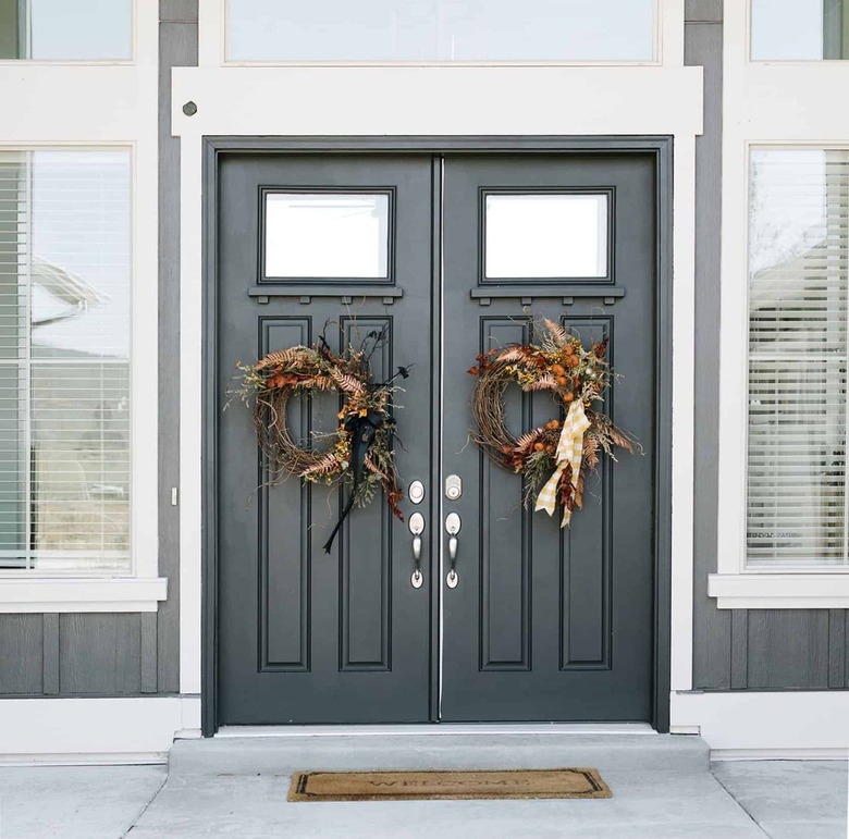 gray front doors with matching wreaths