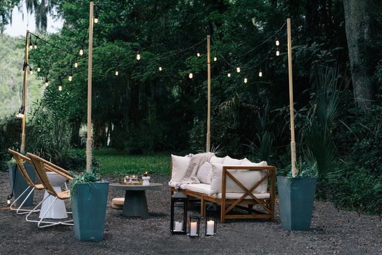 modern outdoor party idea with seating area and string lights and lanterns