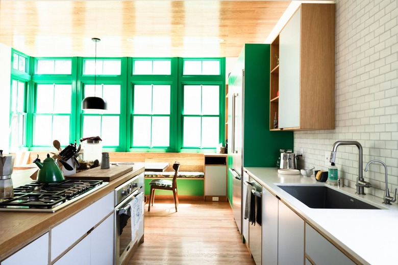 separate range and oven with wood countertops and white cabinets