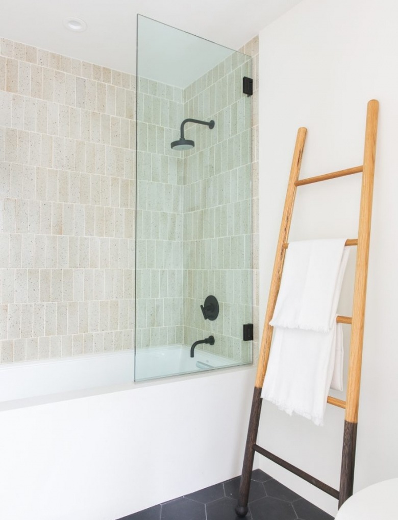 white bathroom with ladder towel rack