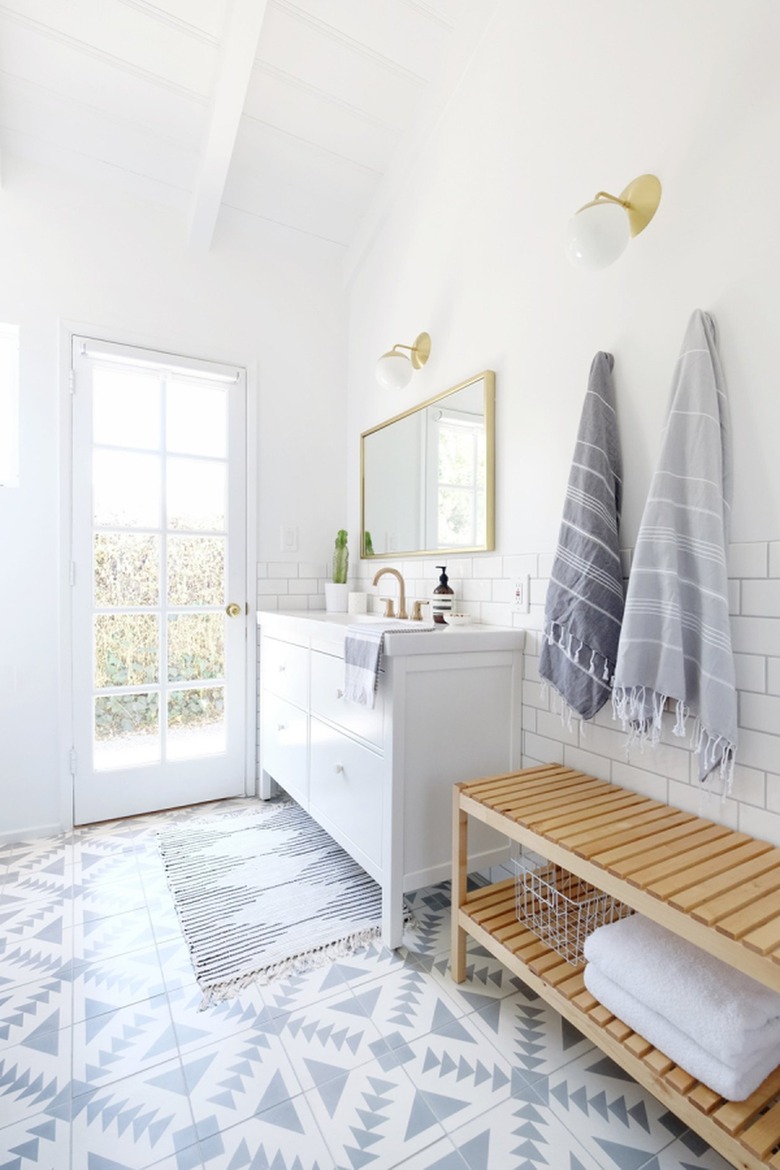 Simple bathroom with light wood bench.