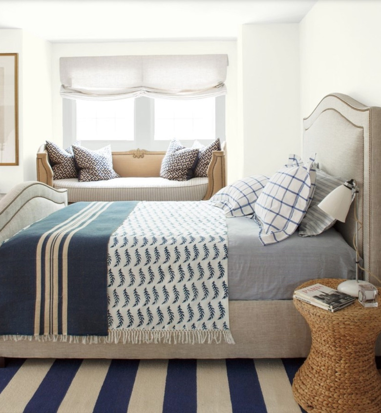 Benjamin Moore's Simply White paint color in bedroom featured window seat and bed with blue linens