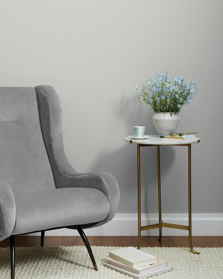 Clare's Seize The Gray paint color on walls in room with grey armchair and side table