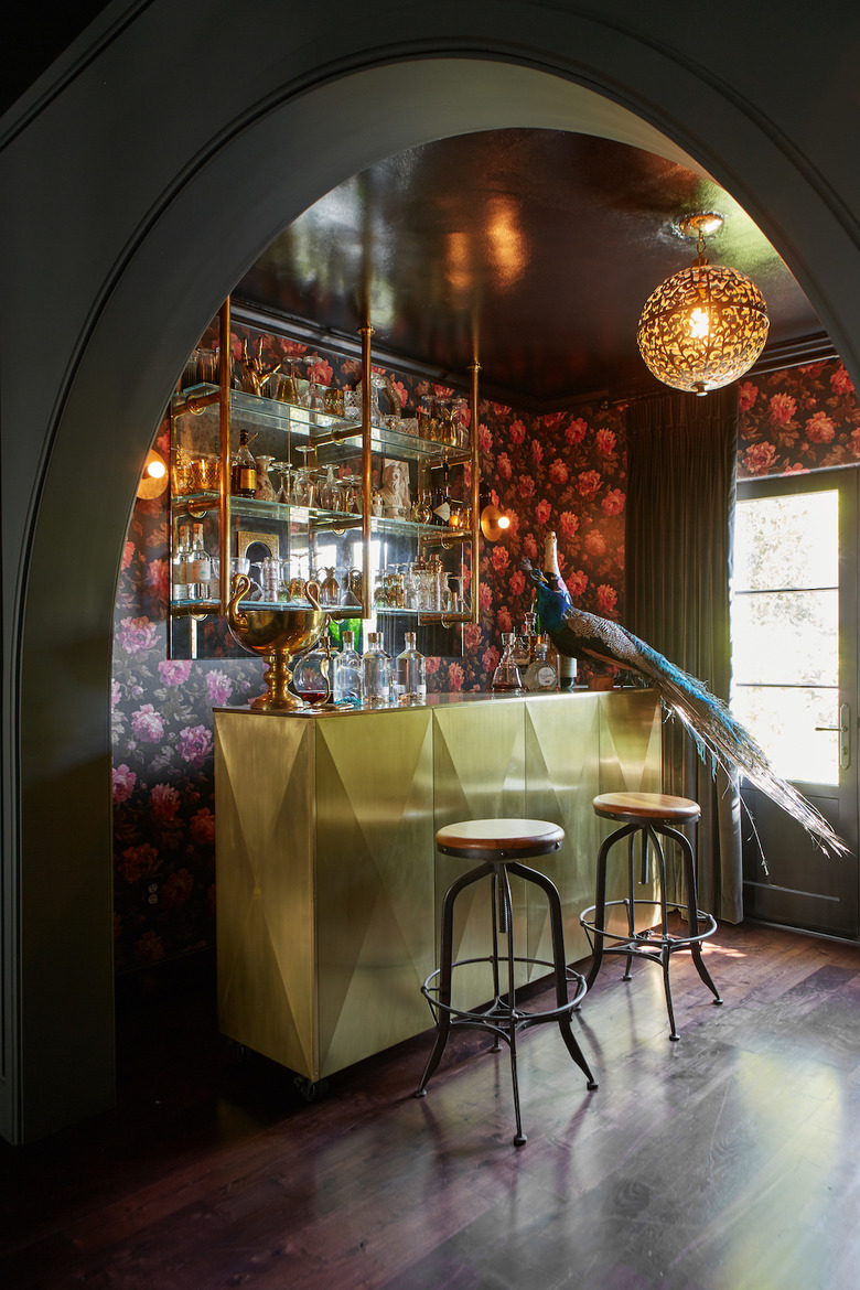 black painted basement ceiling in bar with floral wallpaper