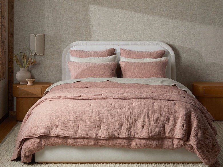 bed with dusty rose linen quilt