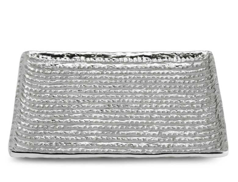 A rectangular silver plate with indentations to look like matzah.