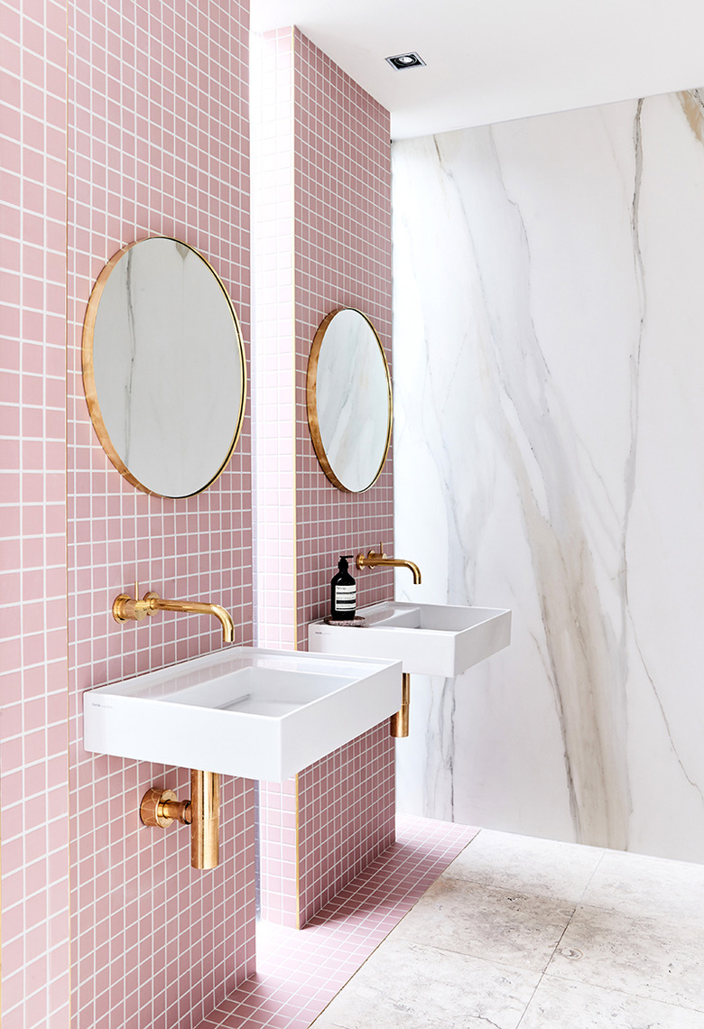 bathroom with pink tile and marble slab walls