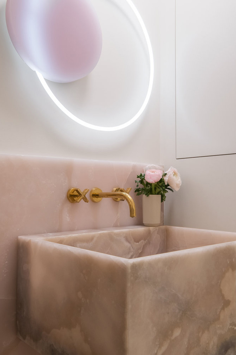 bathroom with pink onyx backsplash and sink