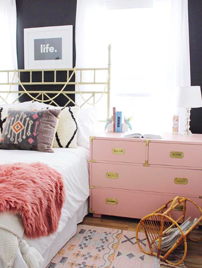 bedroom with pink dresser and faux fur bed throw