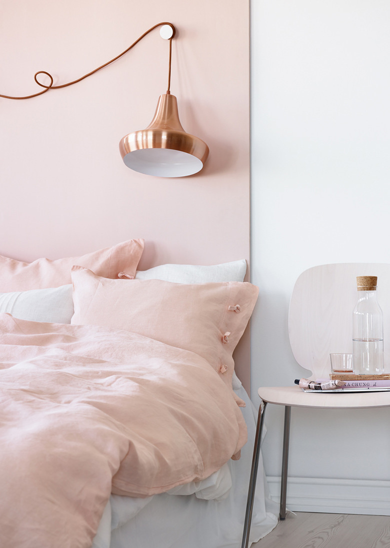 pink bedroom with copper lighting