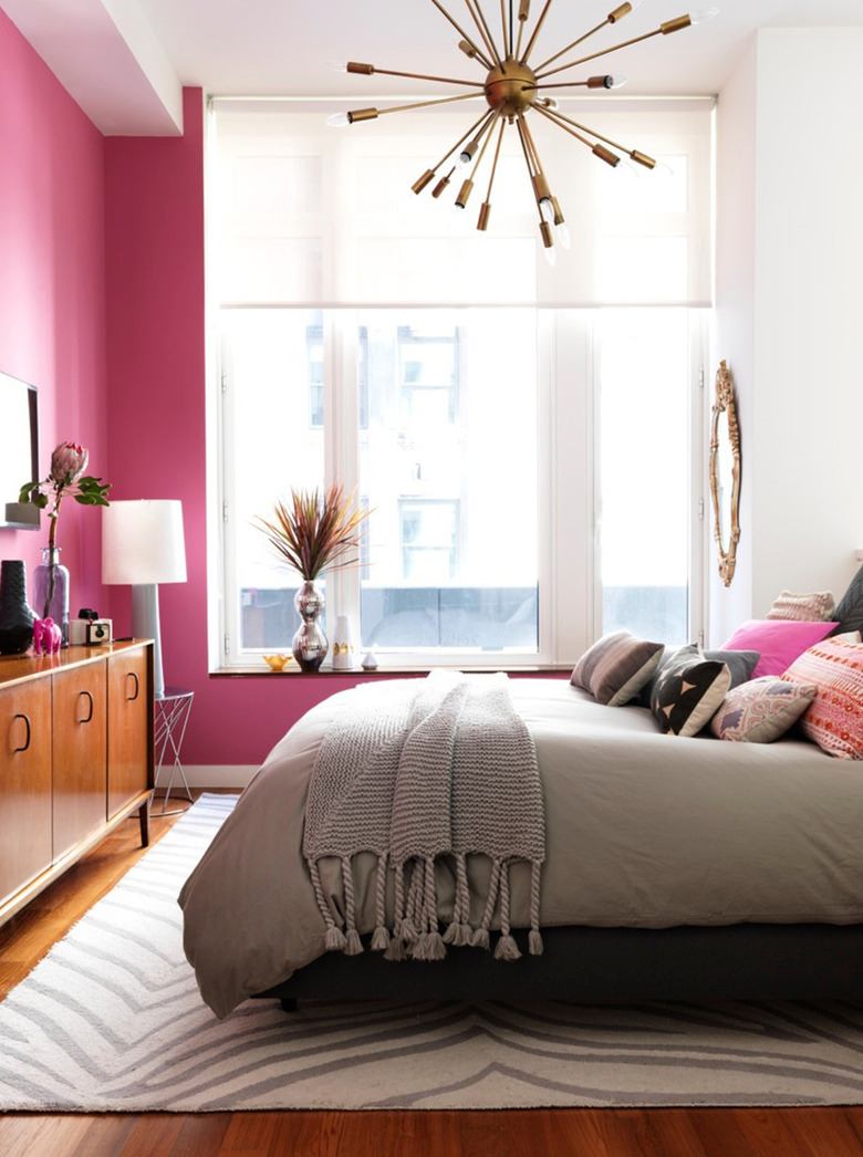 hot pink bedroom with glam chandelier