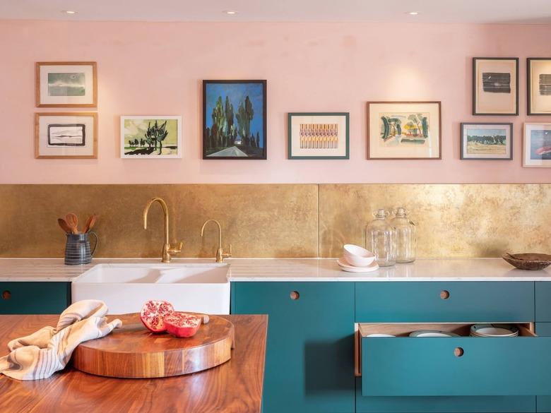 pink kitchen color idea with gold backsplash, pink walls and teal cabinets