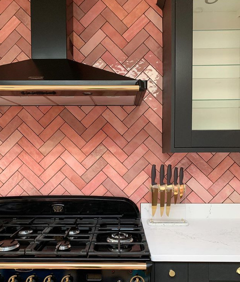 pink kitchen color idea with chevron backsplash and black cabinets