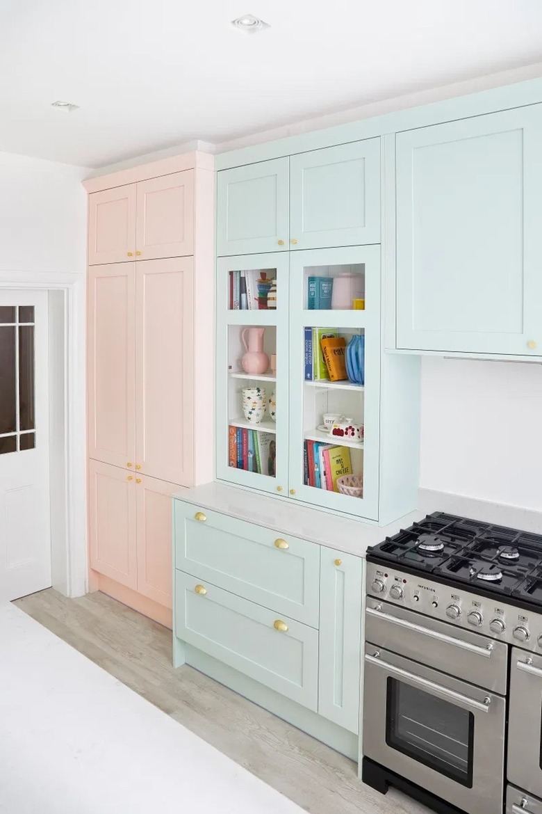 white and blue kitchen with pink accent cabinet