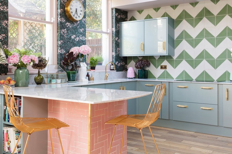 colorful kitchen with blue cabinets and pink tiled island