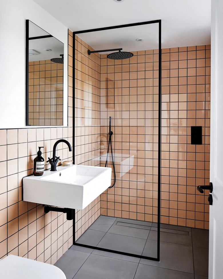 pink tiles with black grout in a modern bathroom with partitioned shower