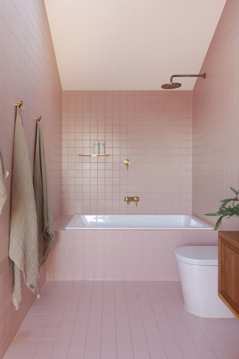 pink bathroom covered in pink tiles