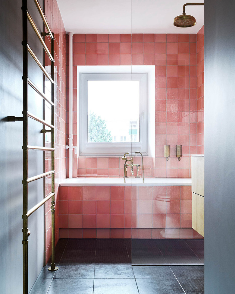 black bathroom with pink glazed tiles in the shower