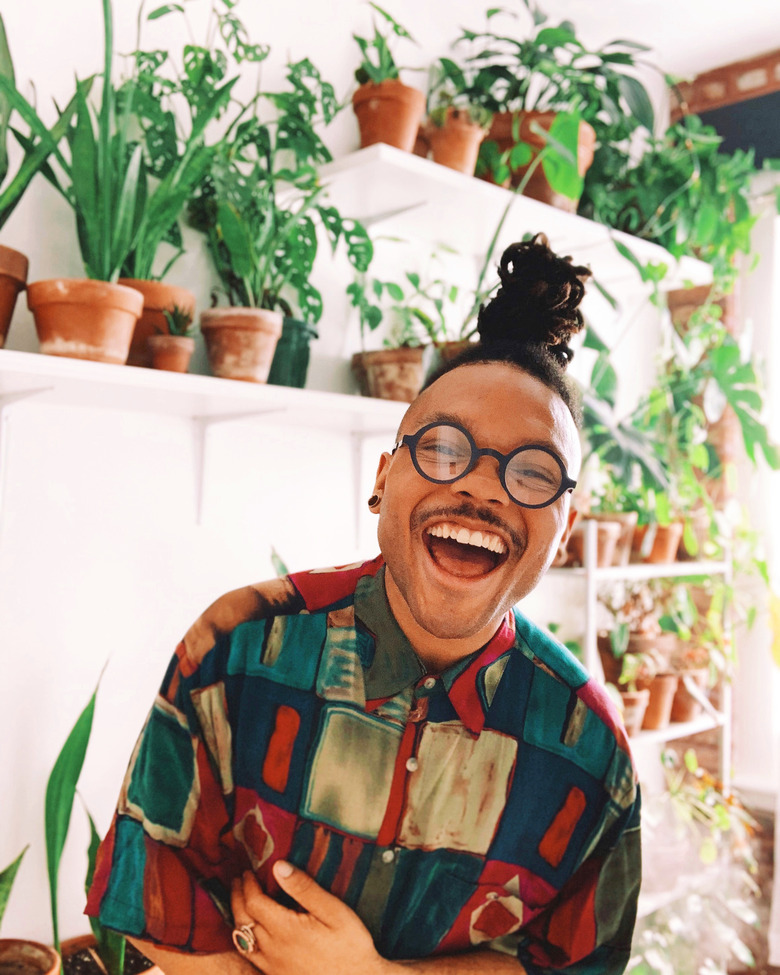 person near shelves with plants