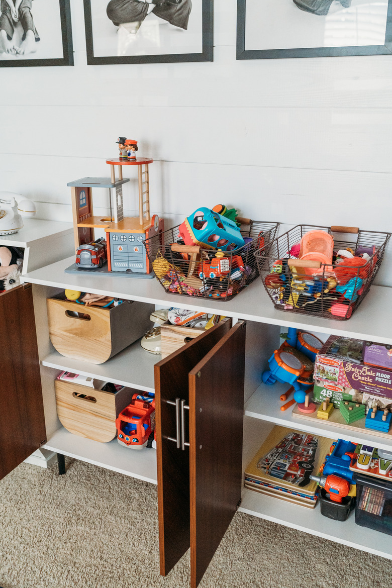 Playroom Organization Ideas with toys in baskets stored in buffet