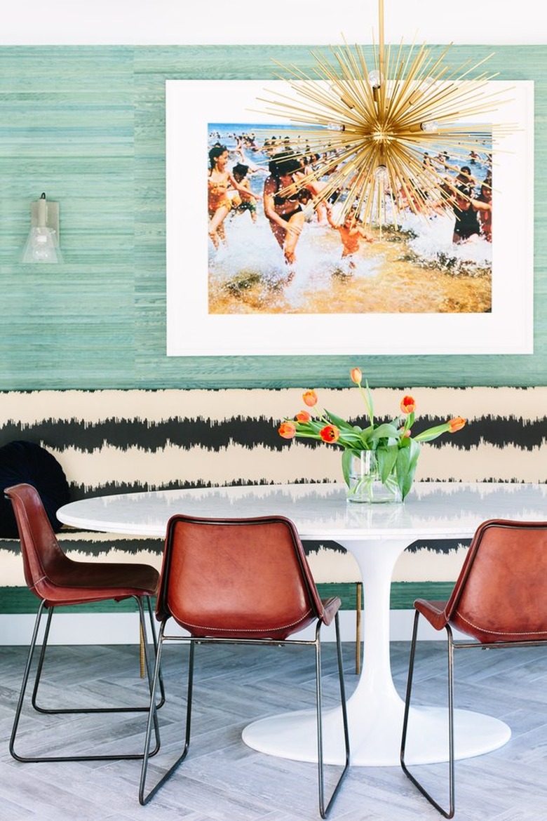 Ecletic dining room  with Saarinen tulip table, brown chairs and patterned banquette