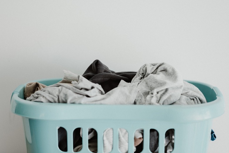 Blue hamper filled with laundry