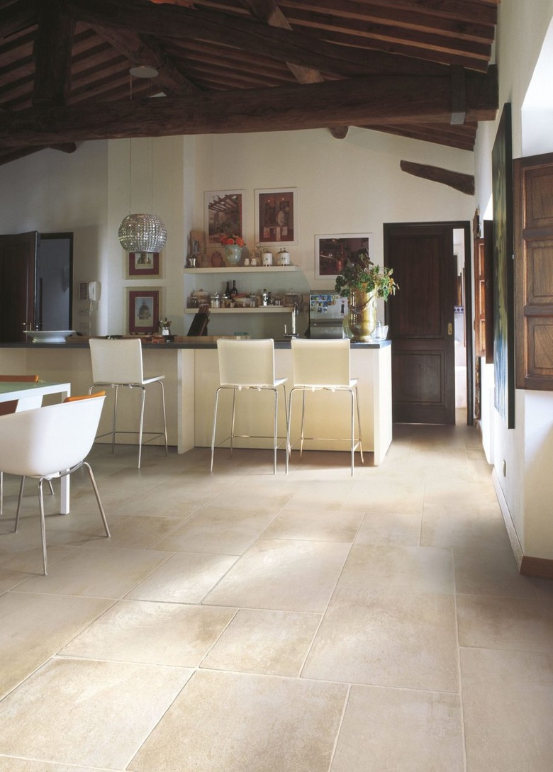 kitchen space with cream tile and bar stools